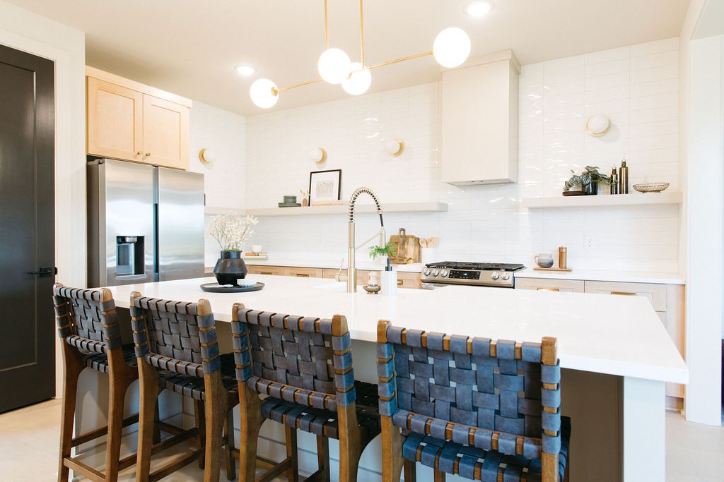 a kitchen with granite countertop a table chairs stove and cabinets