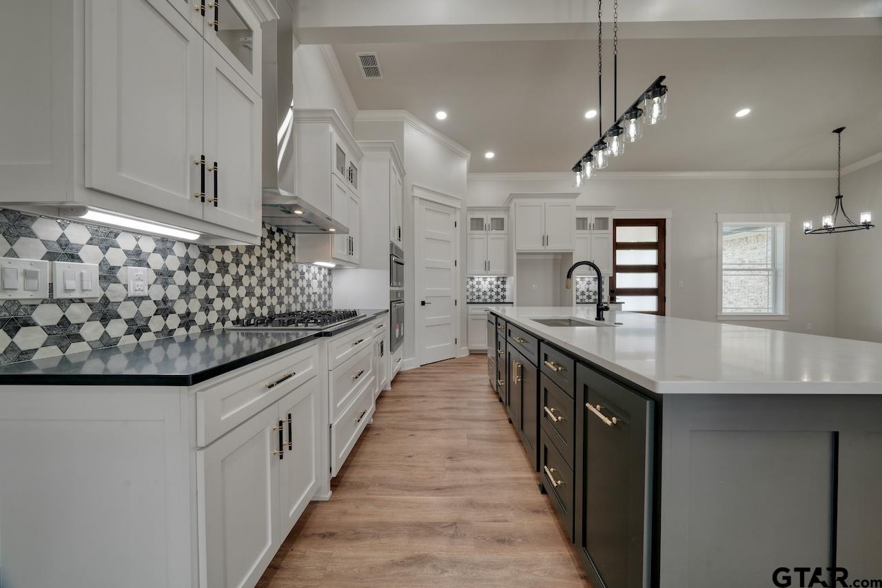 19383 Ridge Point Circle Lindale, TX 75771 - Photo 13 of 48 a kitchen with stainless steel appliances granite countertop a sink and cabinets