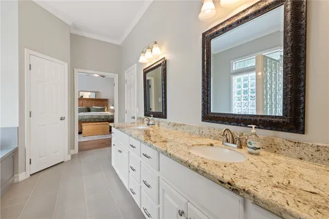 a bathroom with a granite countertop sink mirror and view