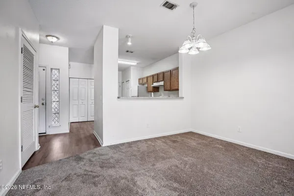 a view of a hallway with chandelier