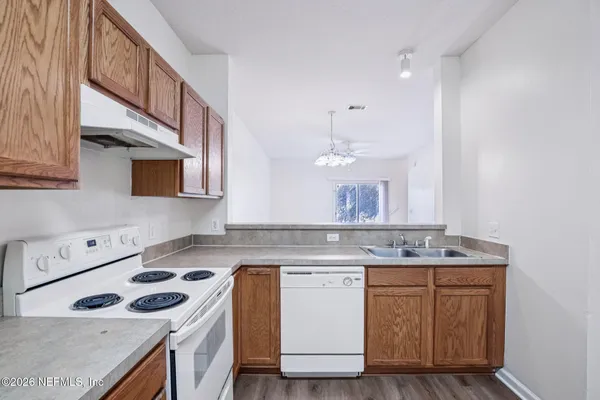 a kitchen with a sink stove and cabinets