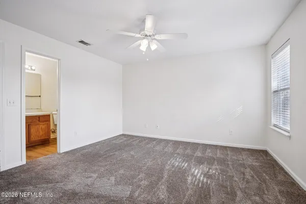 an empty room with windows and closet