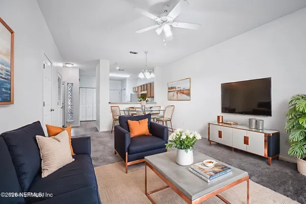 a living room with furniture and a flat screen tv