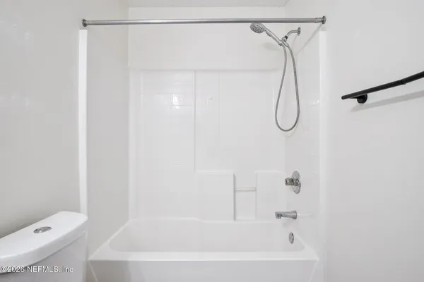 a bathroom with a shower and a toilet