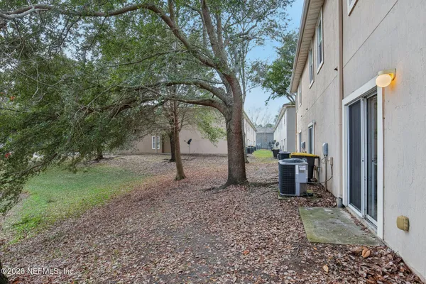 a view of a backyard with large tree