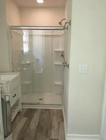 a bathroom with a glass shower door