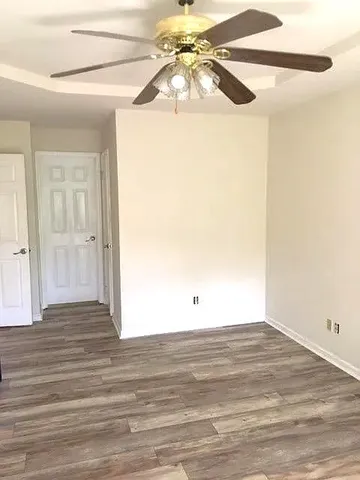 a view of a room with wooden floor