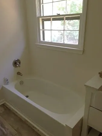 a bathroom with a bathtub and window