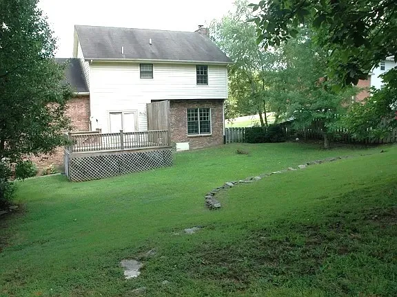 a front view of house with yard and outdoor seating
