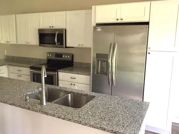 a kitchen with a refrigerator sink and microwave