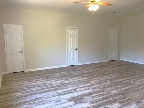 a view of a livingroom with wooden floor and window