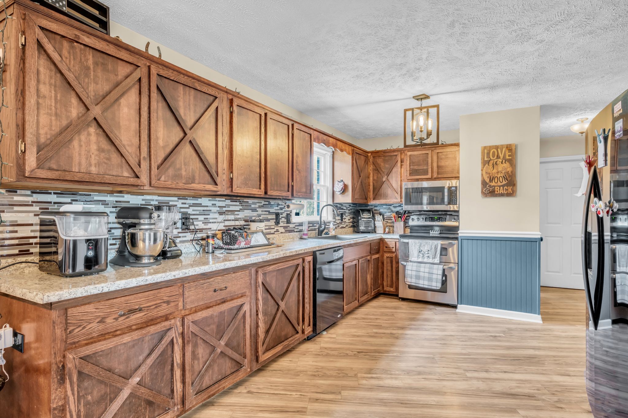 2025 Dunn Chapel Road Cumberland Furnace, TN 37051 - Photo 11 of 37 a kitchen with stainless steel appliances granite countertop a sink dishwasher stove and refrigerator with wooden cabinets
