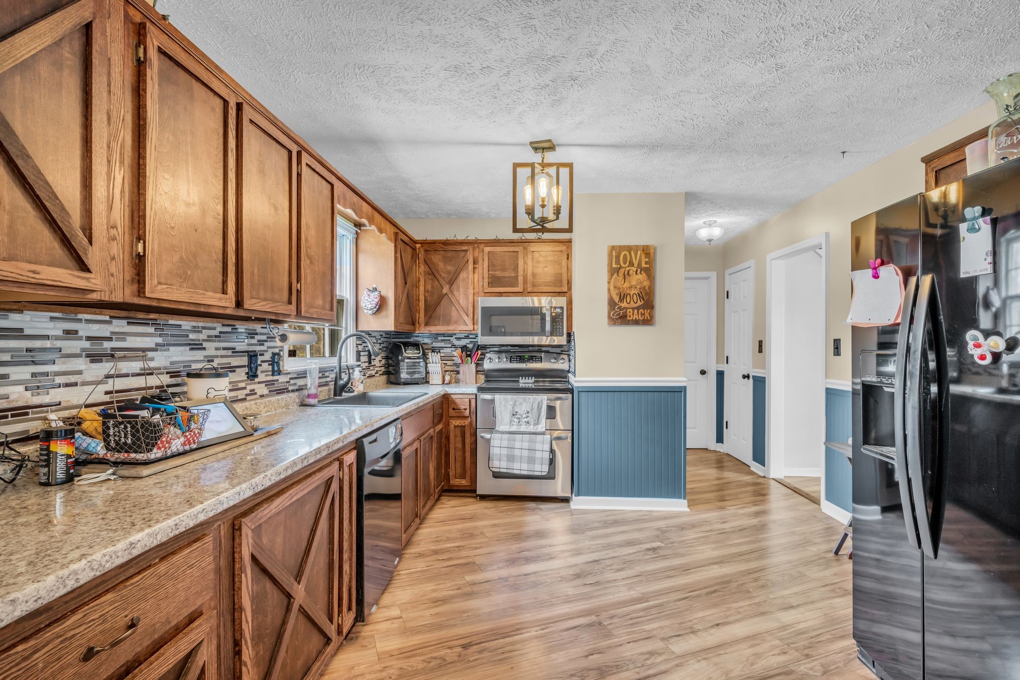 2025 Dunn Chapel Road Cumberland Furnace, TN 37051 - Photo 12 of 37 a kitchen with stainless steel appliances granite countertop a refrigerator a stove top oven a sink and dishwasher