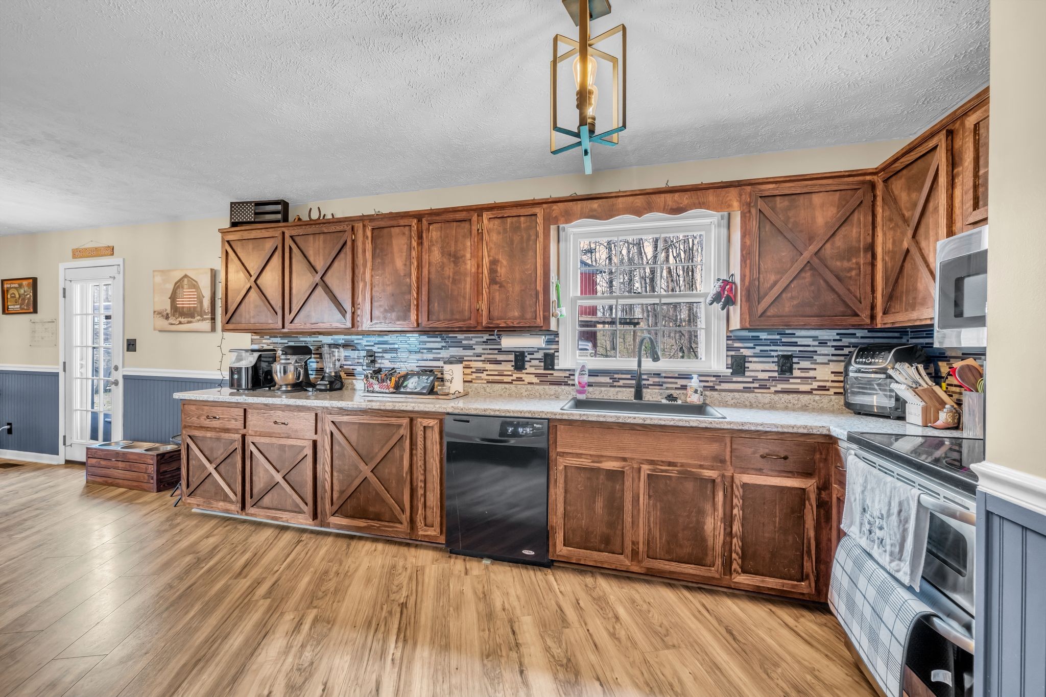 2025 Dunn Chapel Road Cumberland Furnace, TN 37051 - Photo 13 of 37 a kitchen with stainless steel appliances granite countertop a lot of counter space and wooden floors