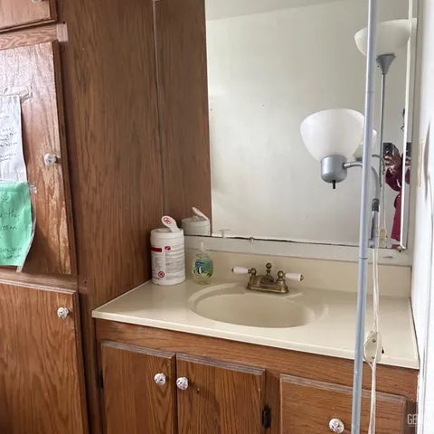 a kitchen with a stove sink and cabinets