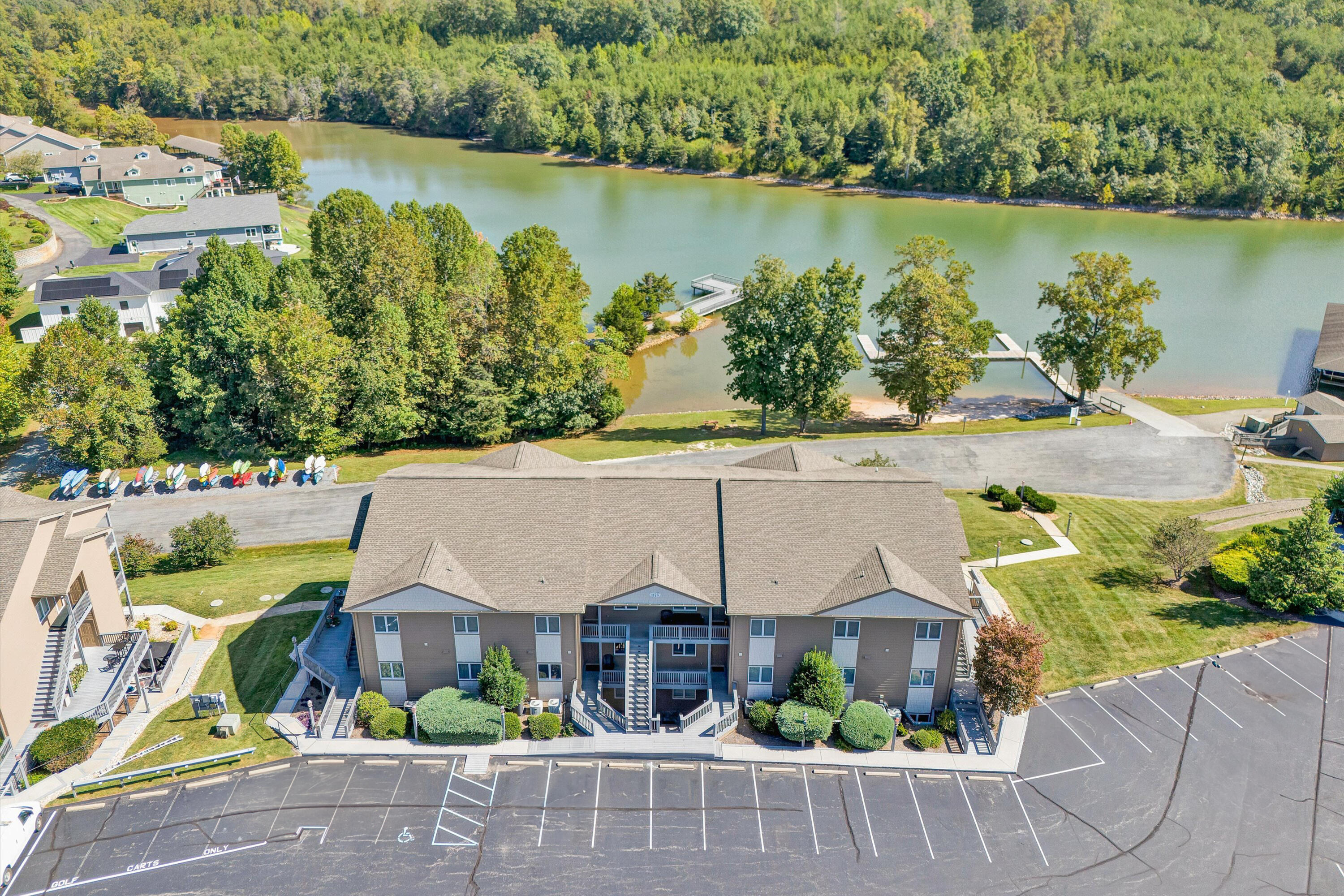 an aerial view of a house with a garden and lake view