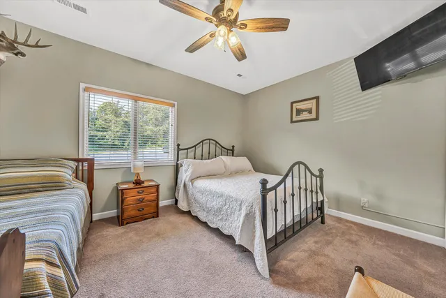 a bedroom with furniture and a window