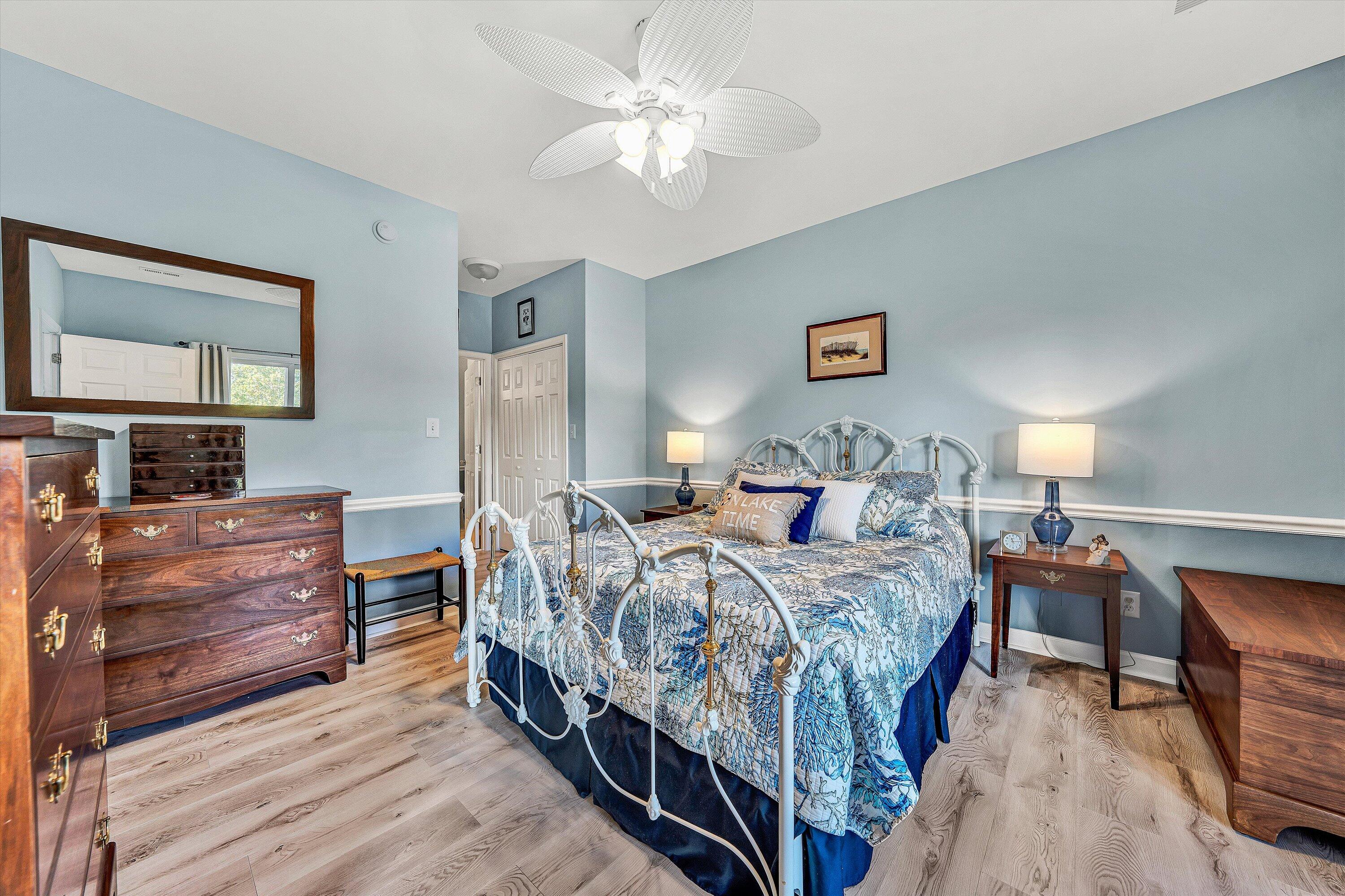 1175 Mariners Way, Unit 54 Huddleston, VA 24104 - Photo 13 of 37 a bedroom with a bed and a chandelier