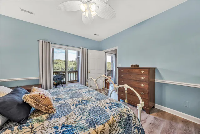 a bedroom with a bed and large windows