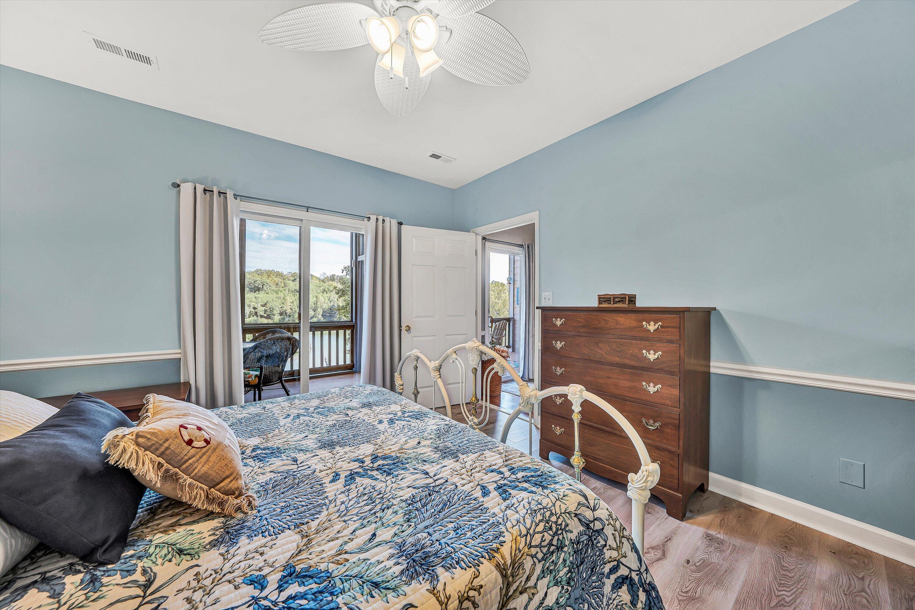 1175 Mariners Way, Unit 54 Huddleston, VA 24104 - Photo 14 of 37 a bedroom with a bed and large windows