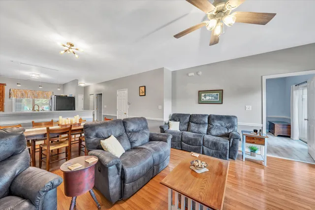 a living room with furniture a couch and wooden floor