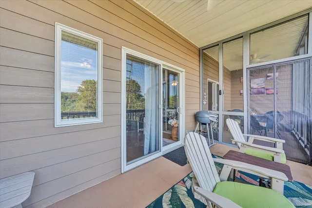 a balcony with table and chairs