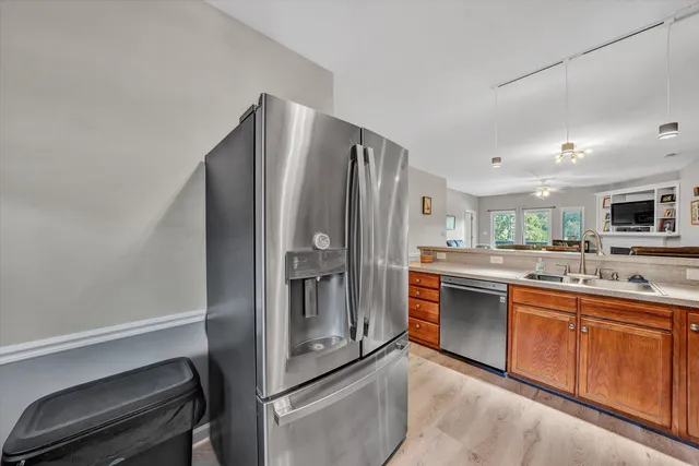 a kitchen with stainless steel appliances a refrigerator and a sink
