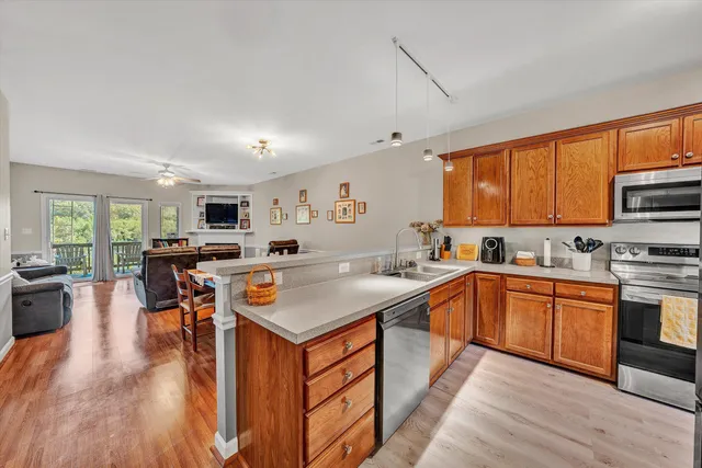 a large kitchen with stainless steel appliances granite countertop a stove and refrigerator