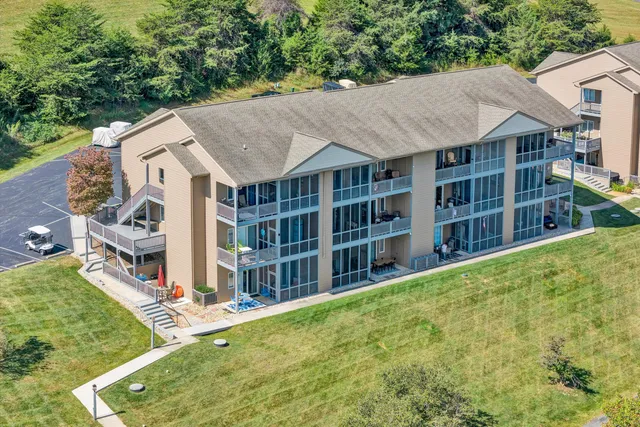 a view of a house with a yard and potted plants
