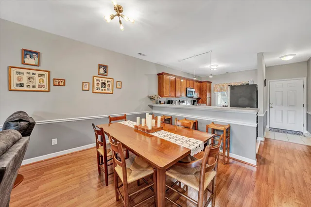 a view of a dining room with furniture and wooden floor