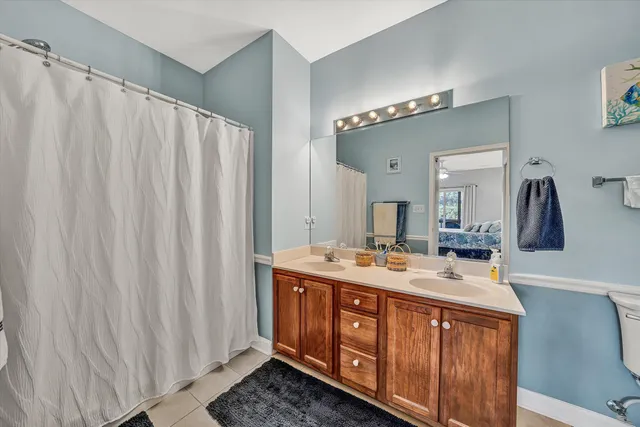 a bathroom with a double vanity sink and mirror
