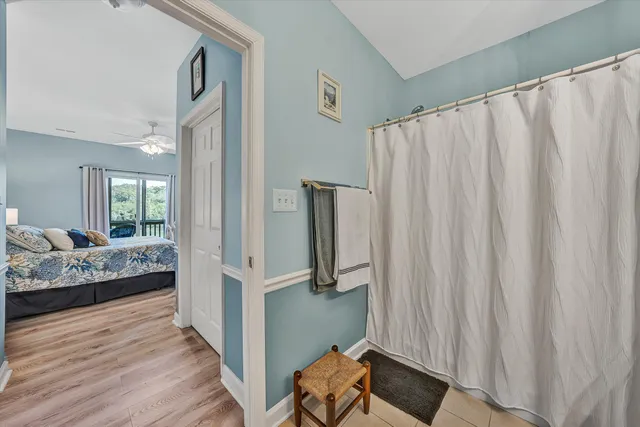 a view of a bedroom with furniture and window