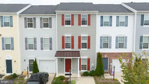 a view of a house with small yard and plants
