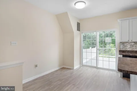 a view of kitchen with wooden floor electronic appliances and window
