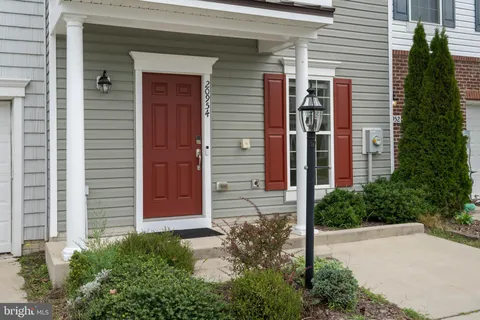 a view of a hallway with wooden floor and entryway