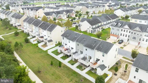 a view of a lake with table and chairs under an umbrella