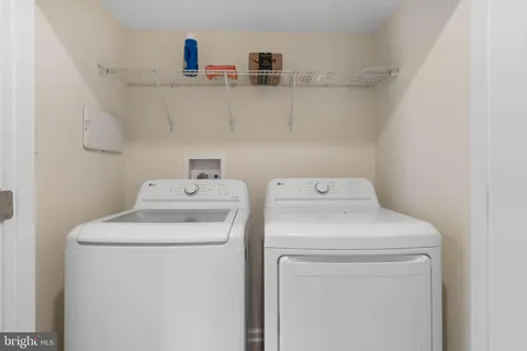 a kitchen with kitchen island wooden cabinets a refrigerator and a stove