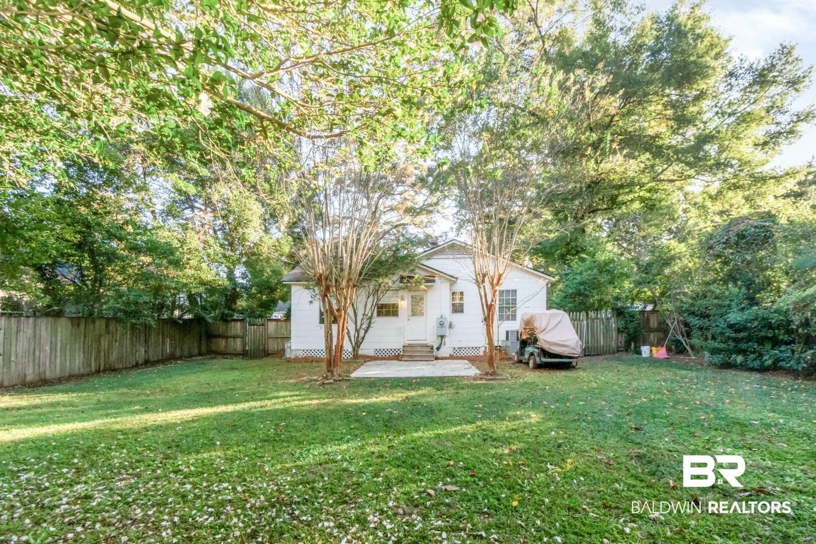 16 Princess Anne Road Mobile, AL 36608 - Photo 33 of 40 Rear view of property featuring a patio, a fenced backyard, entry steps, and view of wooded area