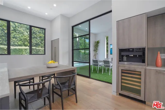 a kitchen with a table chairs and a refrigerator