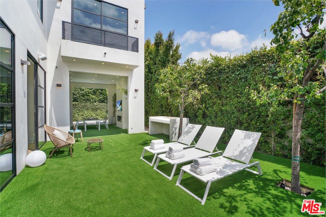 346 North Kings Road Los Angeles, CA 90048 - Photo 16 of 33 a view of a chair and table in backyard of the house