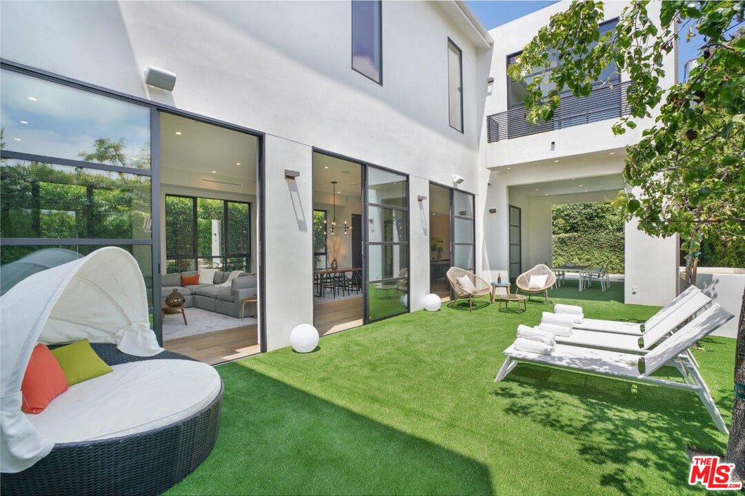 346 North Kings Road Los Angeles, CA 90048 - Photo 17 of 33 a view of a chair and table in backyard of the house