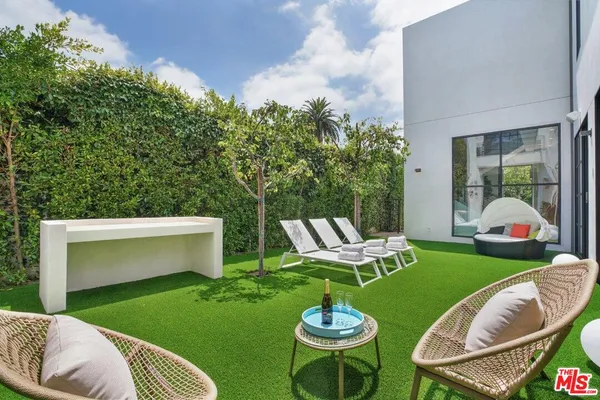 a view of backyard of house and outdoor seating