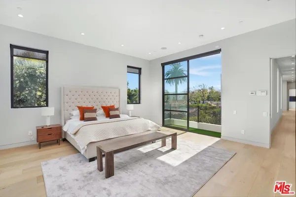 a bedroom with a bed and large window