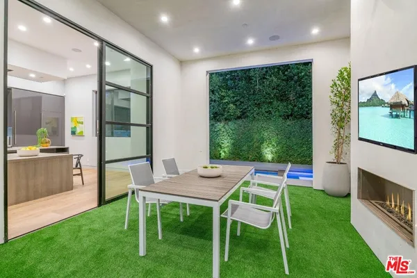 a room with furniture and a open kitchen view