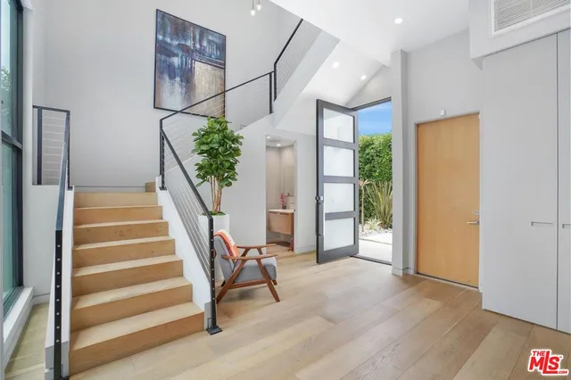 a view of entryway and hall with wooden floor
