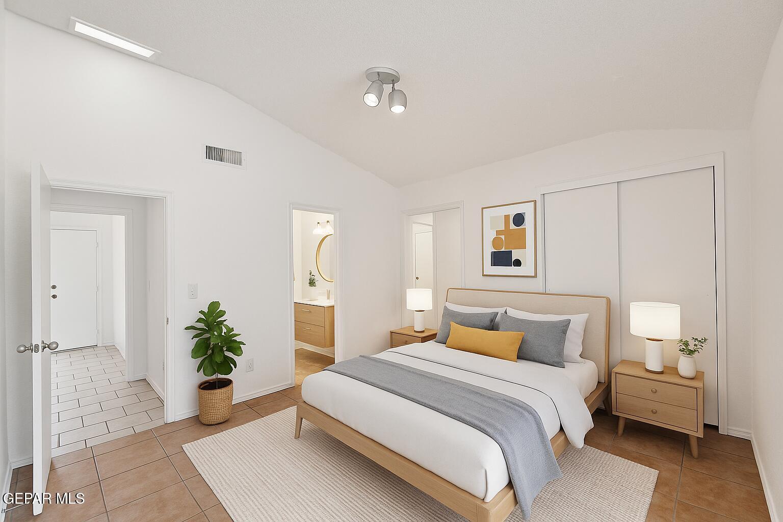 833 Destello Road El Paso, TX 79907 - Photo 12 of 55 a bedroom with a bed and a potted plant