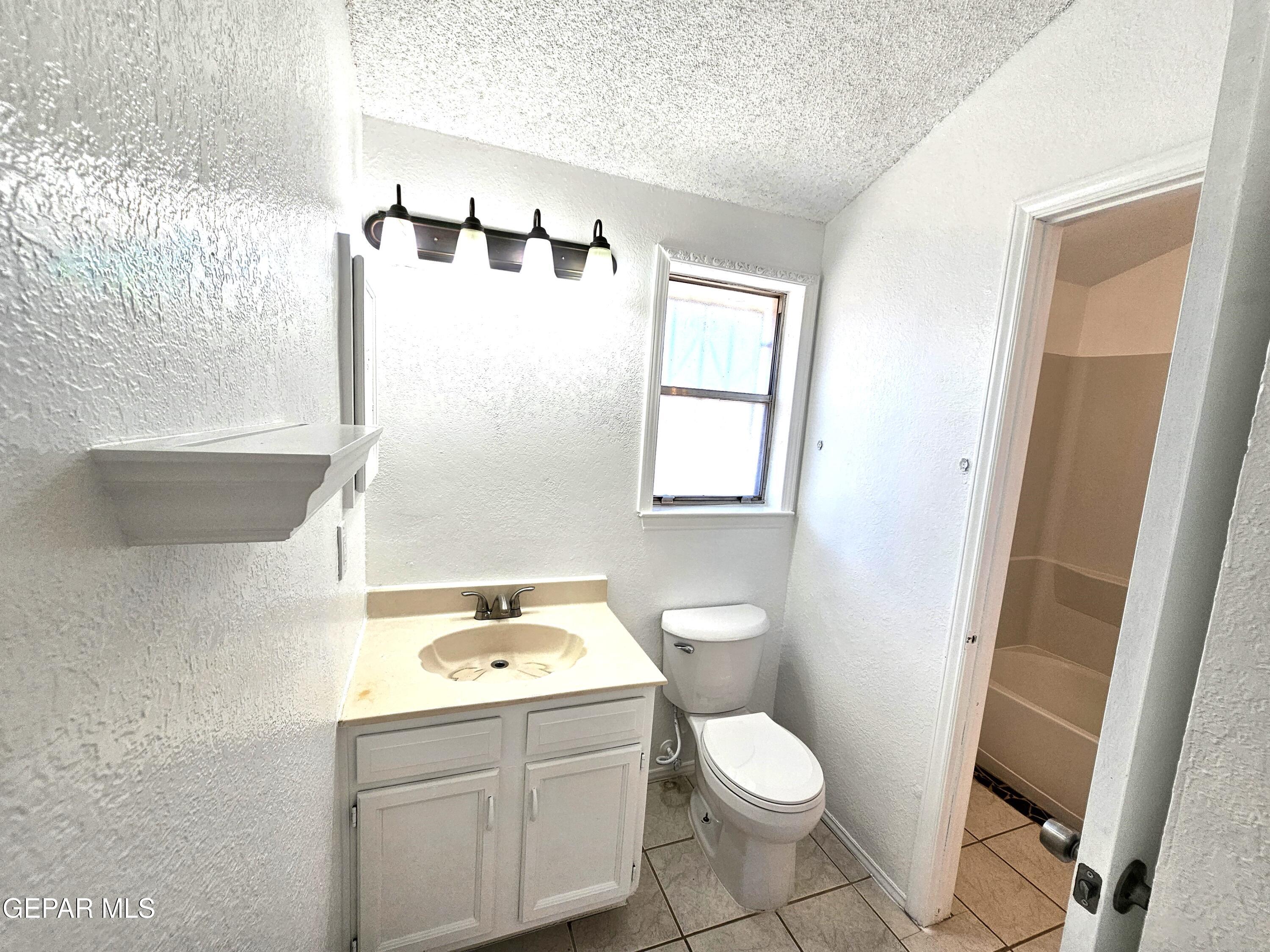 833 Destello Road El Paso, TX 79907 - Photo 22 of 55 a bathroom with a sink toilet and window