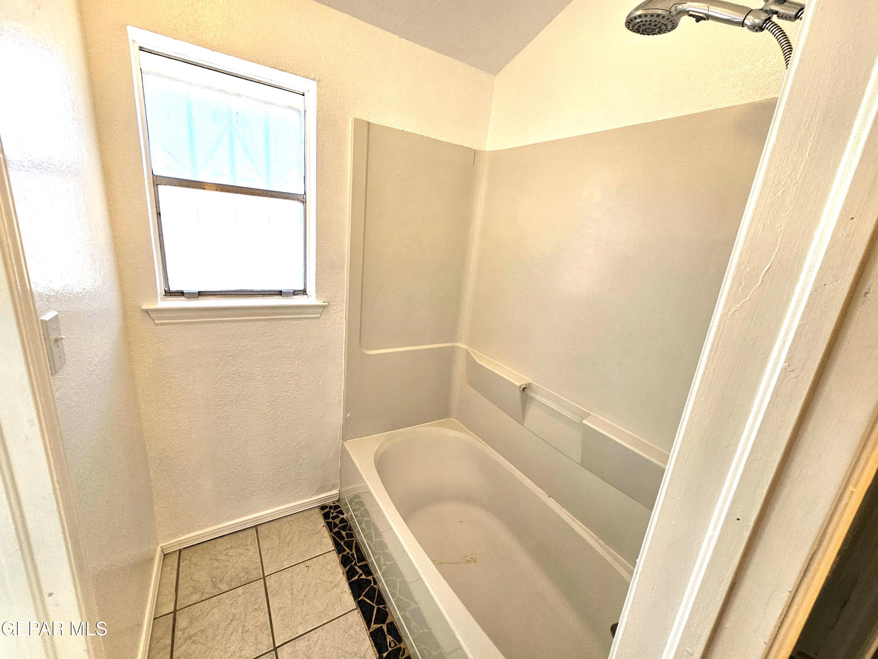 833 Destello Road El Paso, TX 79907 - Photo 23 of 55 a bathroom with a tub and a window
