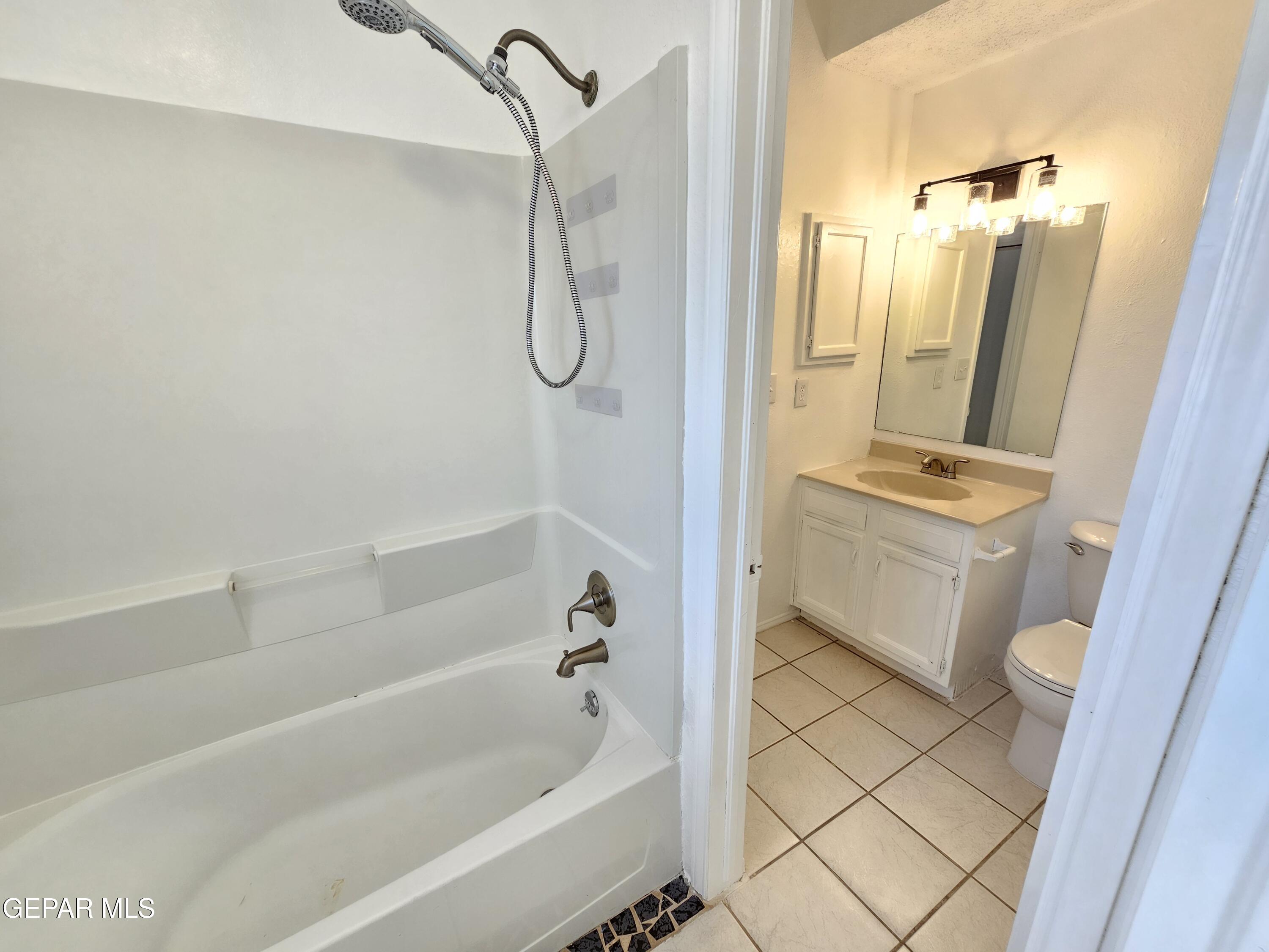 833 Destello Road El Paso, TX 79907 - Photo 24 of 55 a bathroom with a granite countertop sink toilet and shower