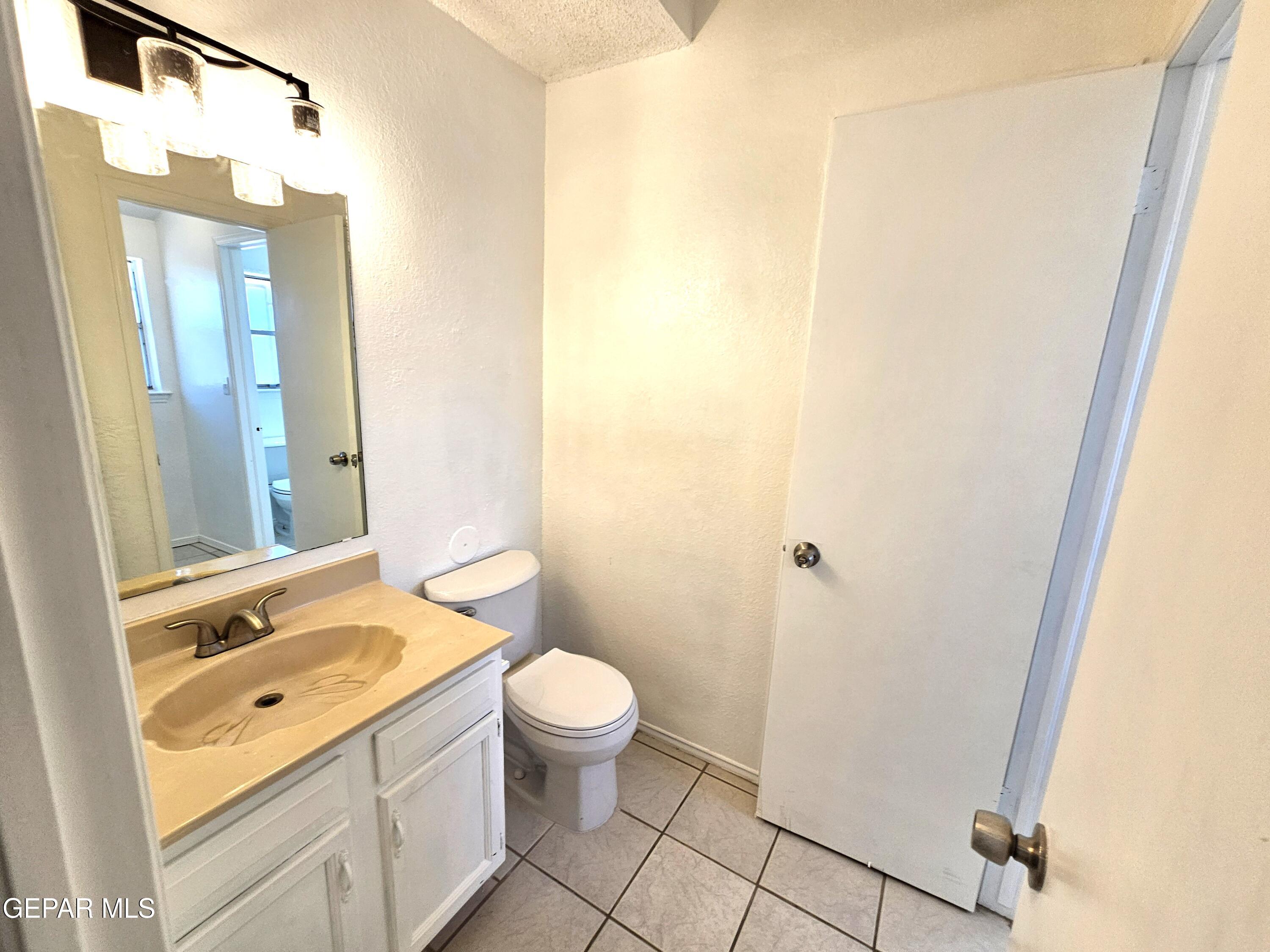 833 Destello Road El Paso, TX 79907 - Photo 25 of 55 a bathroom with a granite countertop sink toilet and shower